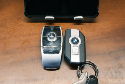 mercedes-and-bmw-car-keys-rest-on-a-table-.jpg Mercedes and BMW car keys rest on a table.